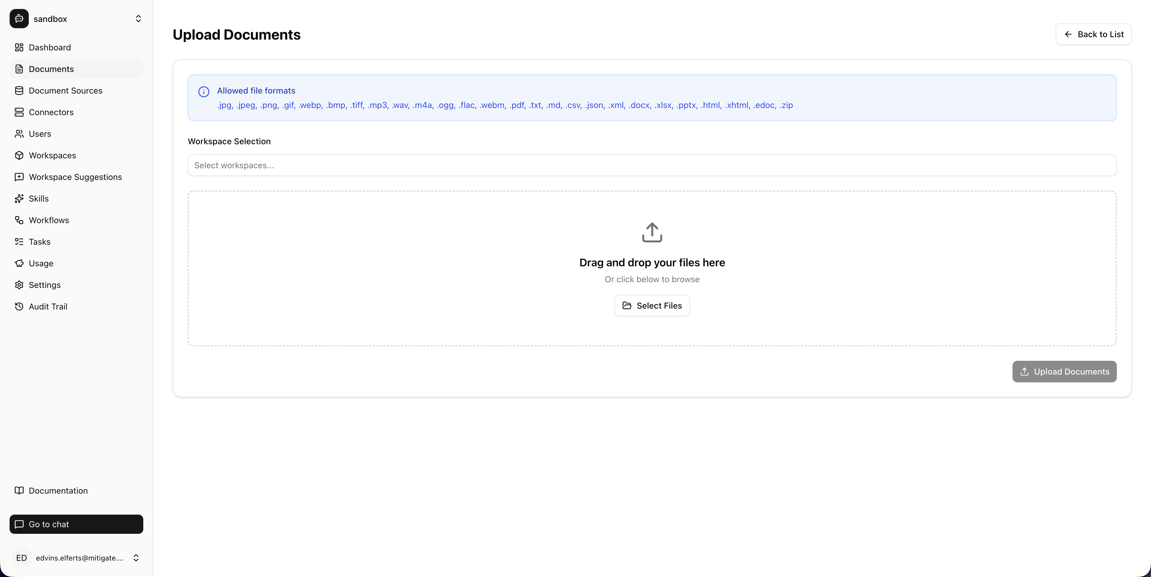 The Mitigate AI knowledge base upload screen, showing supported file formats including PDF, DOCX, XLSX, PPTX, TXT, MD, CSV, JSON, XML, HTML, MP3, MP4, images and ZIP archives